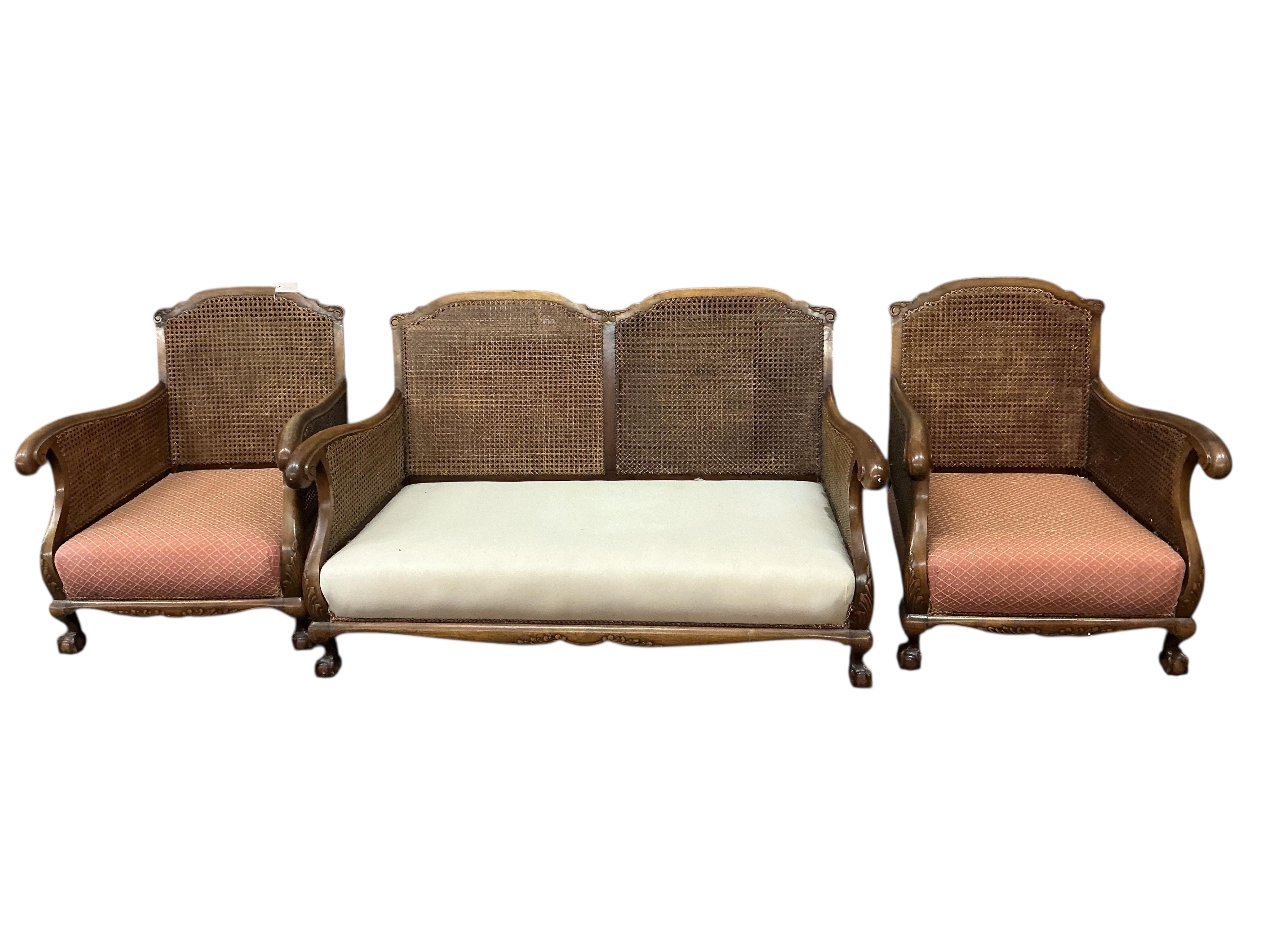 An early 20th century mahogany three piece bergere suite